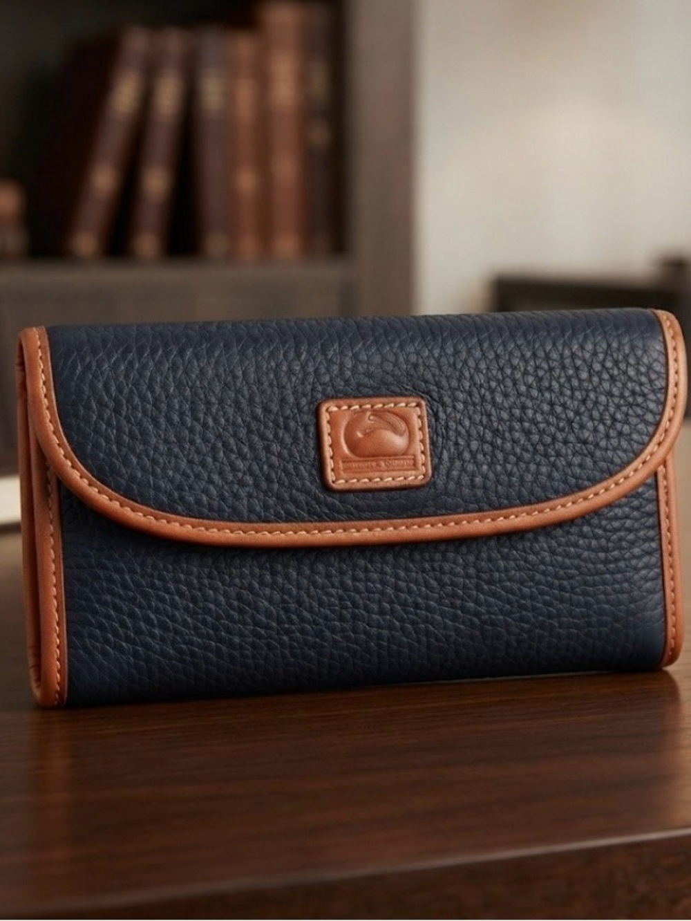 3 1/2”. X. 7”.  pebble-grain leather Dooney & Bourke Continental Clutch